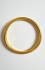 Bracelet bouddhiste BAAN, jonc souple transparent aux feuilles d’or, béni par des moines. Symbole de chance, protection et harmonie. Fabriqué en France.