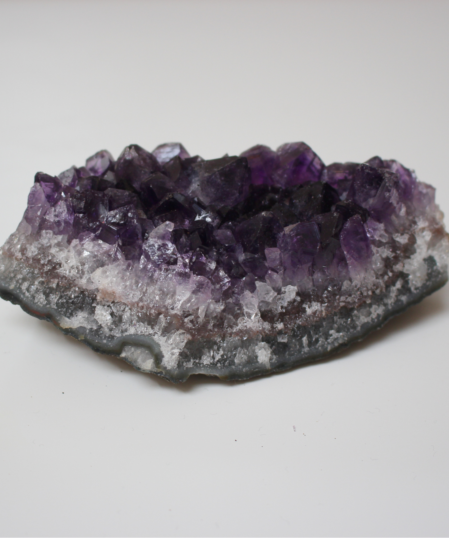 Cette magnifique druse d’améthyste naturelle de 203 grammes provient des mines familiales d’Uruguay, réputées pour offrir les cristaux les plus intenses et les plus purs du monde. Sélectionnée pour son excellente qualité  AA, cette pièce présente un violet profond. Non traitée, 100 % naturelle, elle a été extraite dans des conditions respectueuses de l’humain et de l’environnement. Elle convient aussi bien à la lithothérapie qu’à la méditation ou encore à la décoration et la diffusion de ses énergies dans l